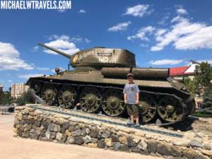 a man standing in front of a tank