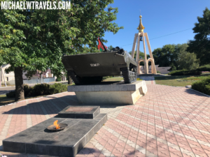 a tank on a pedestal in front of a fire pit