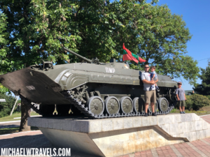 a group of people standing on a military tank