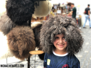 a child with a fluffy wig