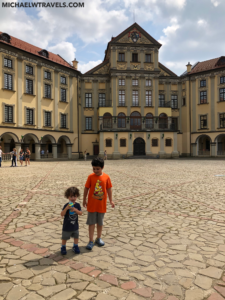 two children standing in a courtyard of a building