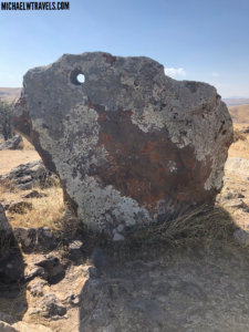 a large rock with a hole in it