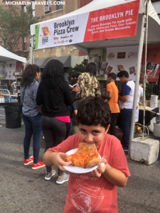 a boy eating a slice of pizza