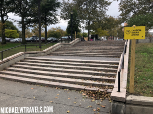 a set of stairs with a yellow sign