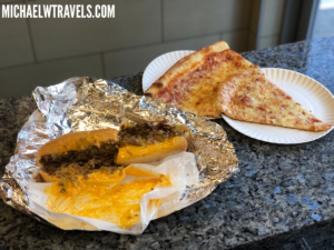 a plate of pizza and cheese pizza on a counter