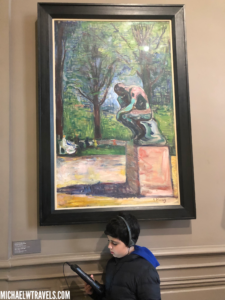 a boy looking at a painting