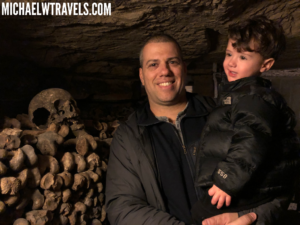 a man holding a child in a cave