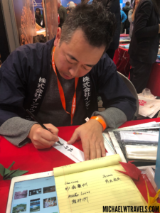 a man writing on a piece of paper
