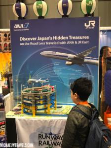 a boy looking at a toy model of an airplane