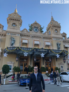 a man standing in front of Monte Carlo Casino