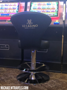a black chair in front of a casino slot machine
