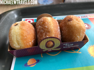 a box of doughnuts on a tray