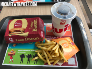 a tray with french fries and a drink on it