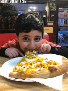 a boy eating a pizza