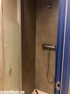 a shower with a blue door