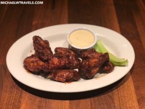 a plate of chicken wings and sauce