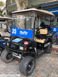a golf cart parked on a brick road