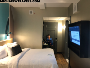a boy standing in a hotel room