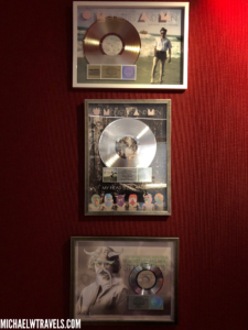 a group of framed records on a wall