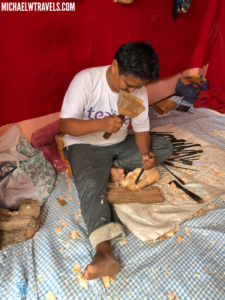 a person sitting on a bed with tools