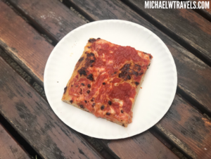 a plate of pizza on a wood table