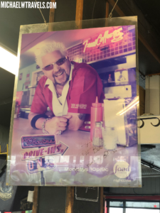 a poster of a man in a pink shirt
