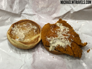 a fried chicken sandwich with butter on top