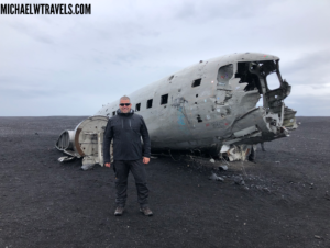 a man standing in front of a crashed plane