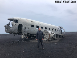 a man standing in front of an old plane