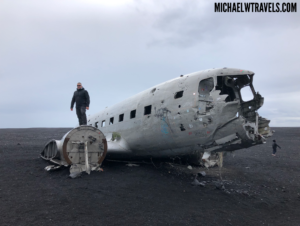 a man standing on a plane wreck