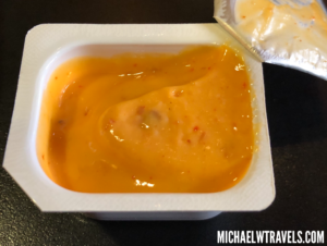 a container of food with a sauce in it