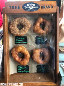 a group of donuts in a case