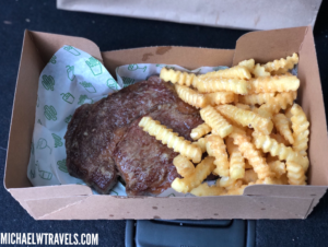 a box of food with meat and fries