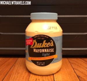 a jar of mayonnaise on a wood surface