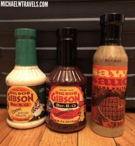 a group of sauce bottles on a wood surface