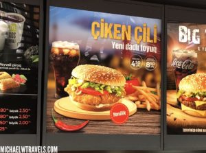 a menu board with images of food and drinks