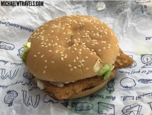 a chicken burger on a paper wrapper