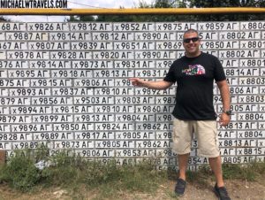 a man standing in front of a wall of numbers
