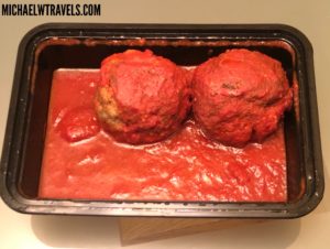 a tray of meatballs in red sauce