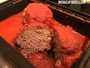 a tray of meatballs with sauce
