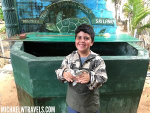 a boy holding a turtle in his hands