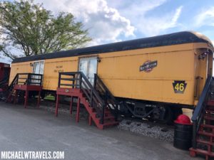 a yellow train car parked on tracks