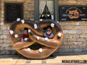 two people sitting in a giant pretzel