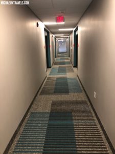 a long hallway with blue and white carpet