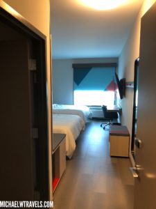 a room with two beds and a desk