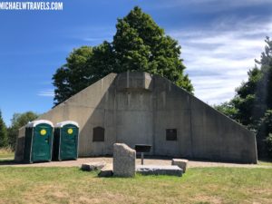 a concrete structure with two portable toilets