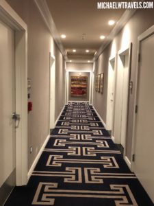 a hallway with a carpet and doors