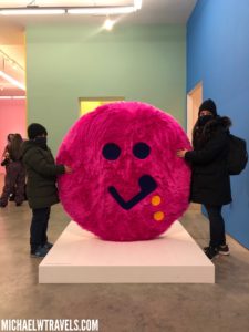 a group of people holding a large pink object