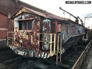 a rusty train car on tracks