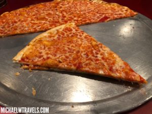 two slices of pizza on a metal tray
